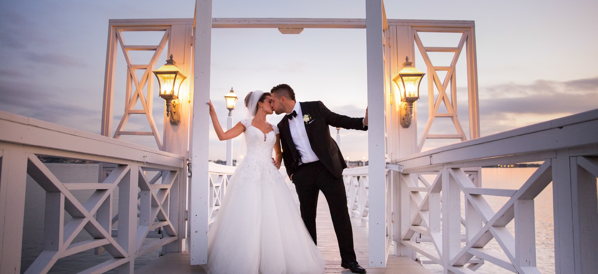 Wedding Photographer Capturing a Bride & Groom Kissing